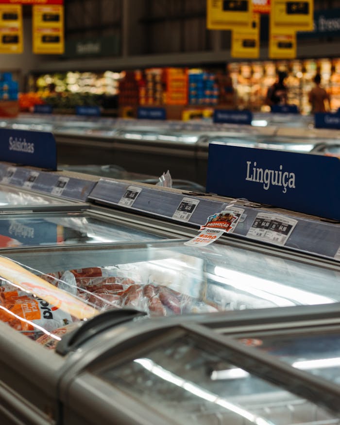 Frozen meats on display in a Brazilian supermarket aisle. Great for commerce and retail themes.